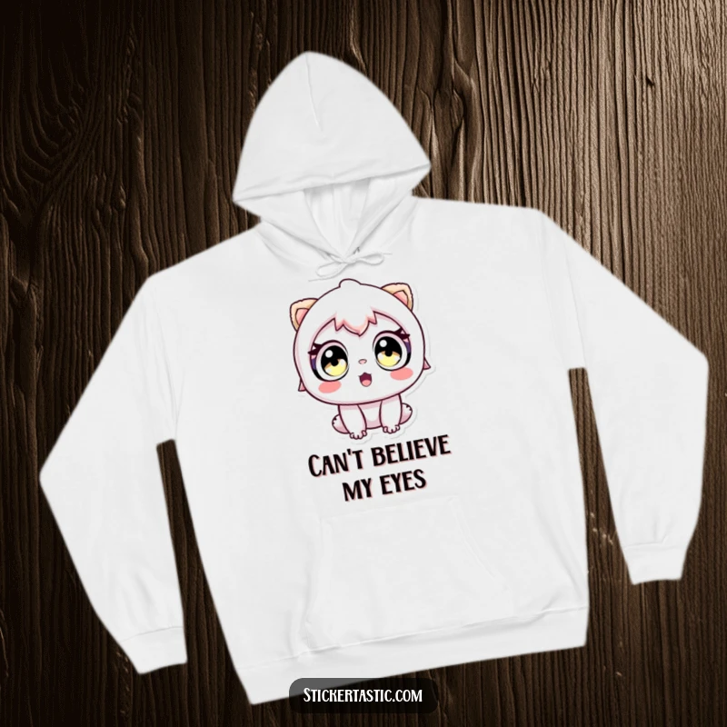 Funny hoodie depicting a character with wide, amazed eyes looking at a sticker, perfect for art lovers.
