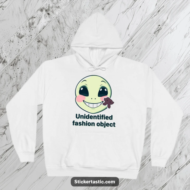 Funny grinning alien face with a sticker on its cheek hoodie, a mischievous alien with a sticker and a wide smile, perfect for humorous warmth.