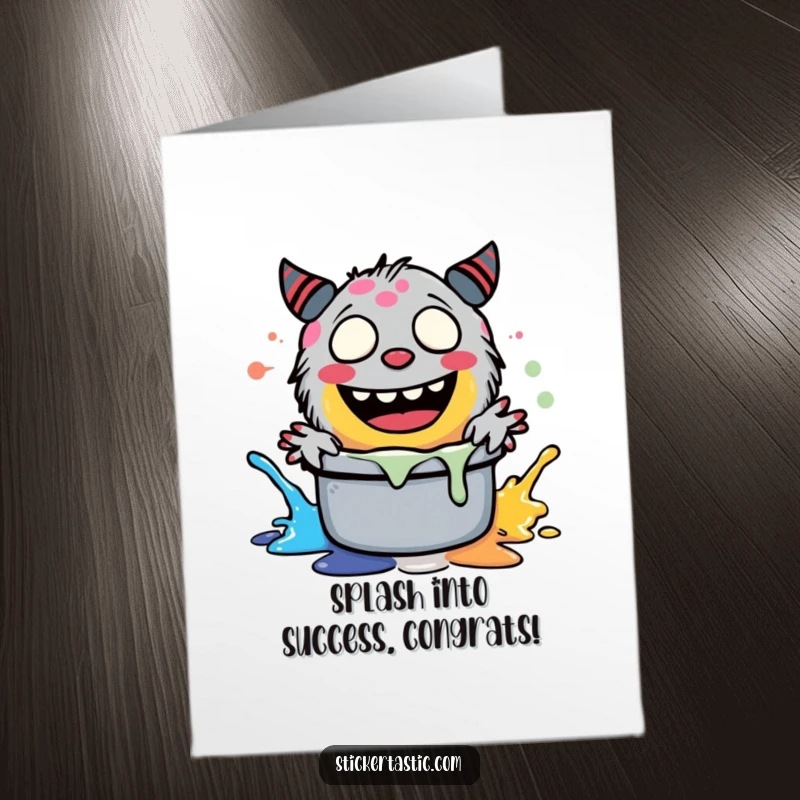Free printable congratulations card: A happy, giggling monster character splashing paint, perfect for celebrating achievements with humor.